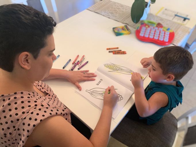 woman and son coloring together